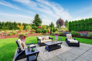 Impressive backyard landscape design with concrete patio area