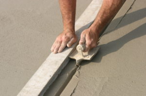 someone installing concrete edging