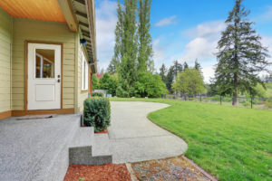 home with curved concrete walkway