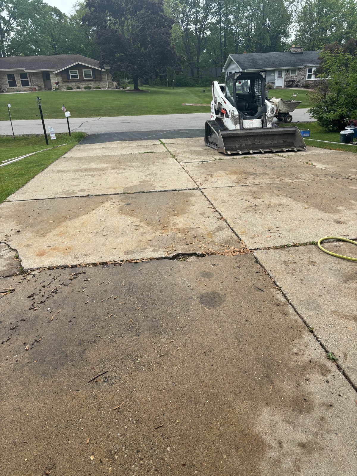 Before: the driveway as equipment arrives for removal.
