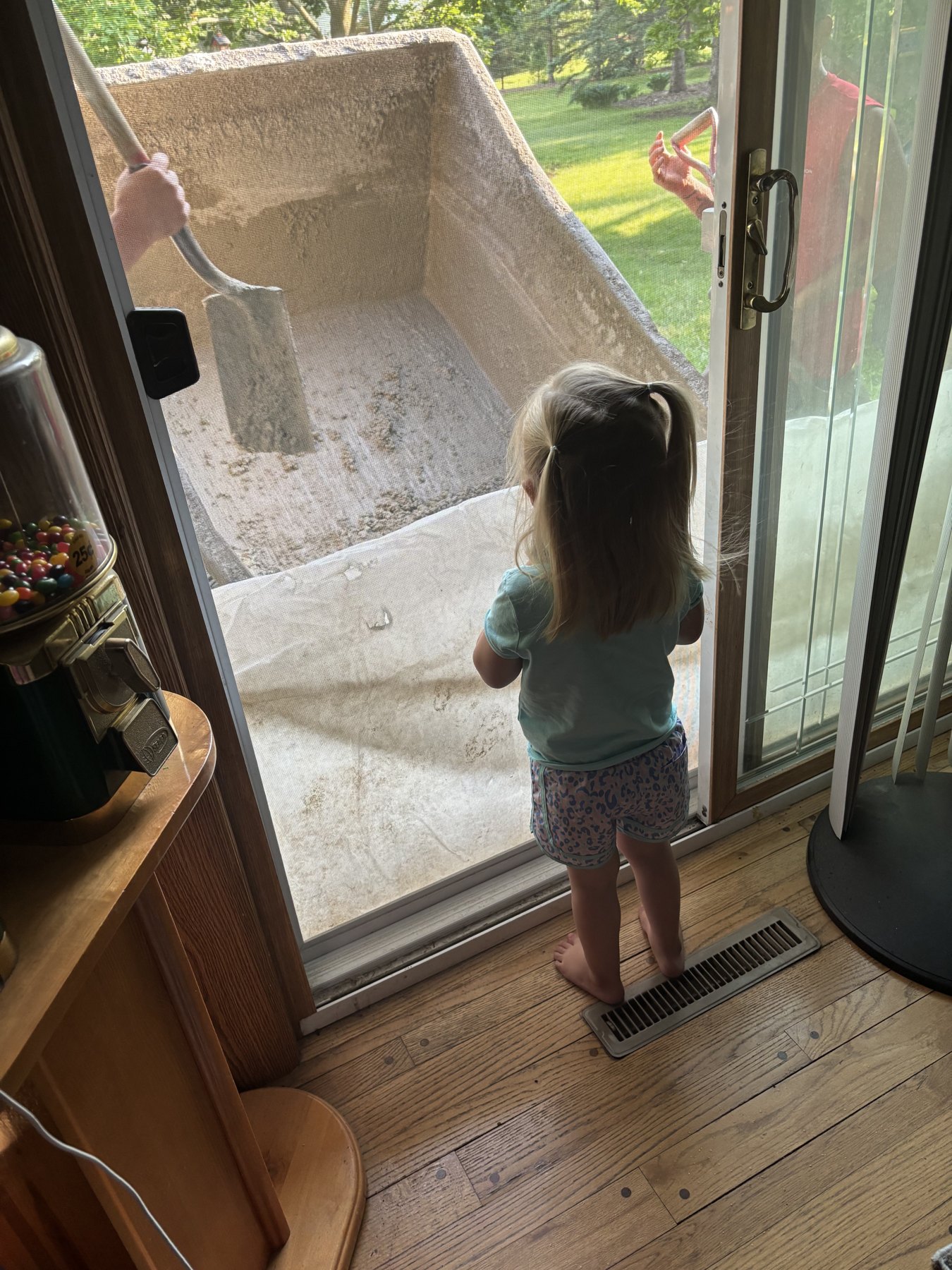 A child watches the concrete work from the doorway in a photo supplied by the homeowner